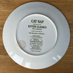 White plate with 'Cat Nap Classics' and 'Kitten Classics' text on a wooden surface