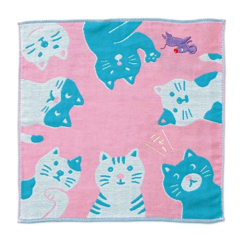 Pink towel with blue cat patterns on a white background