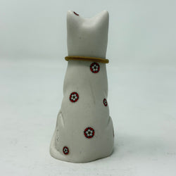 A white resin lucky cat figurine with a brown collar and Yorkshire Rose decoration - rear view