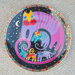 Decorative plate with colorful cat design on a textured surface