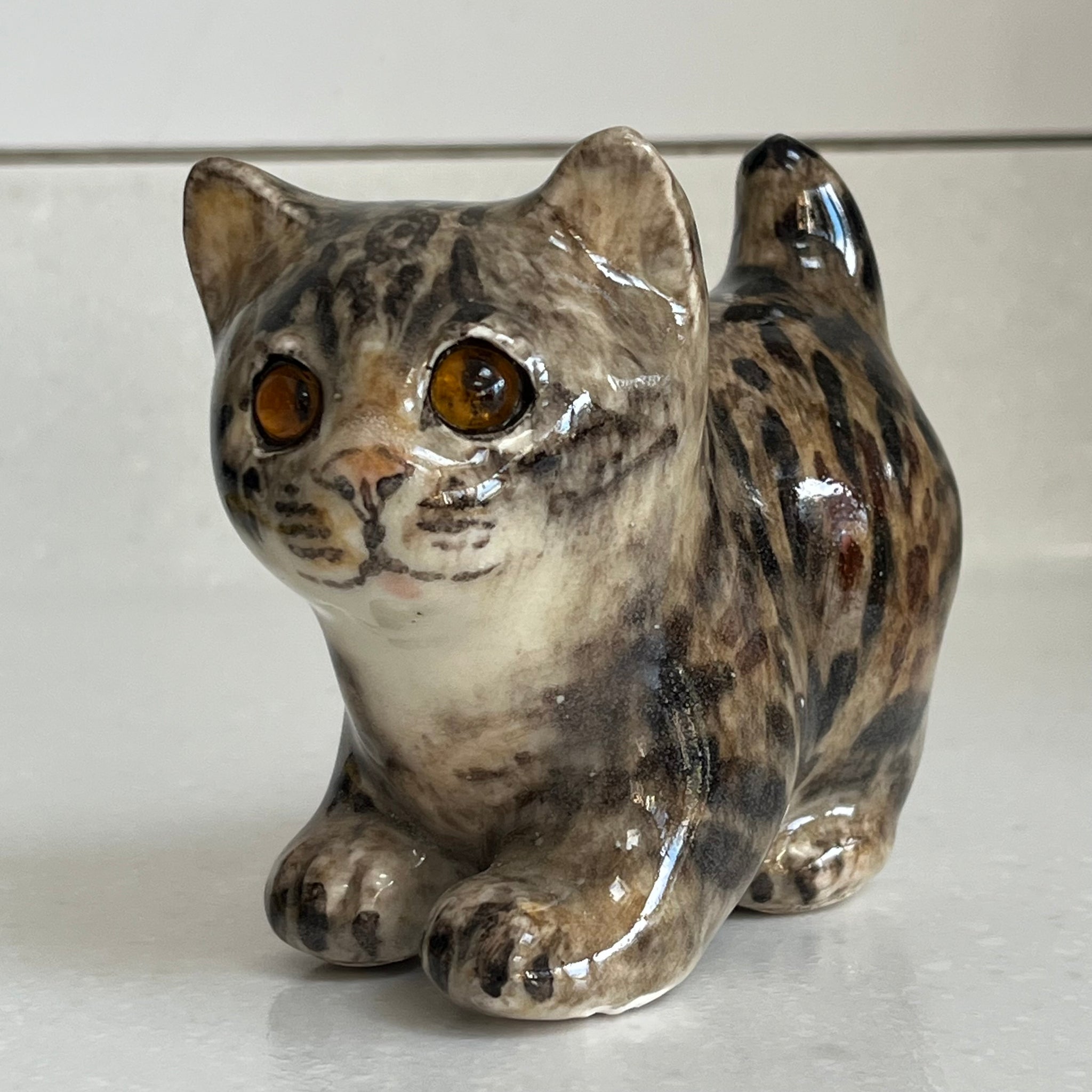 Ceramic cat figurine with brown and black stripes on a white background Winstanley size 1