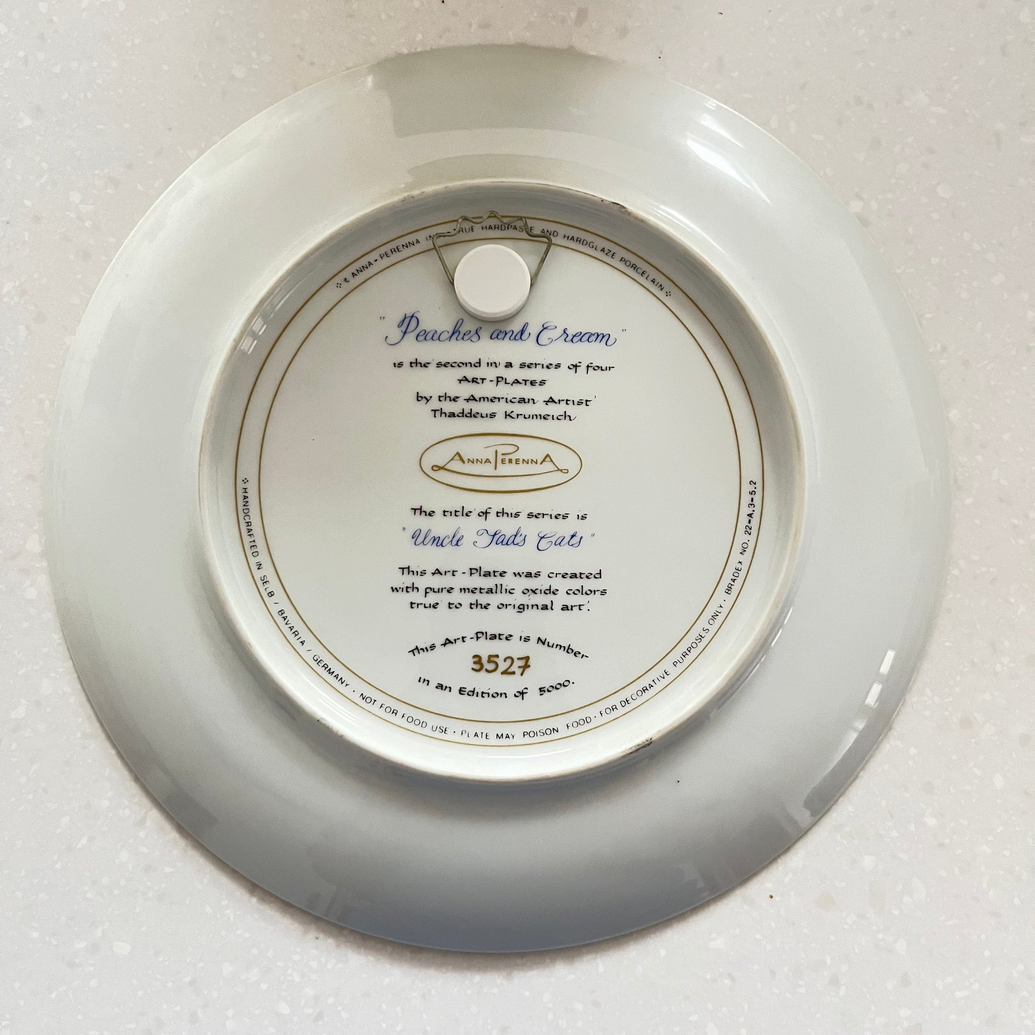 Round white plate with text and a logo on a white background