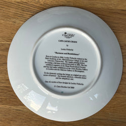 White plate with engraved text on a wooden surface