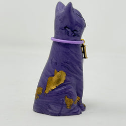 A purple lucky cat ornament with gold foil accents and lilac collar with P charm - side view