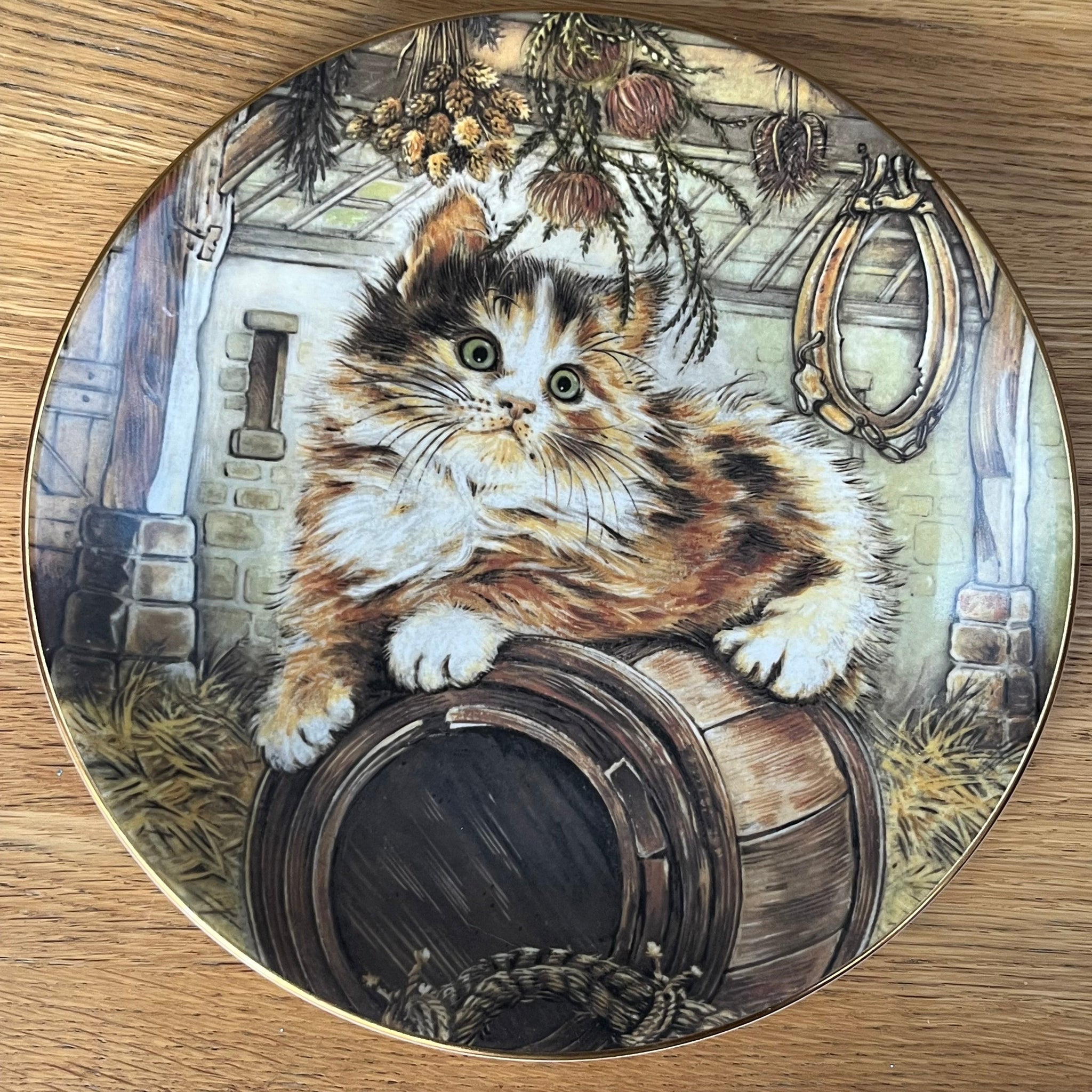 Decorative plate with a cat design on a wooden surface