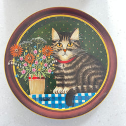 Decorative plate with a cat and floral design on a white background