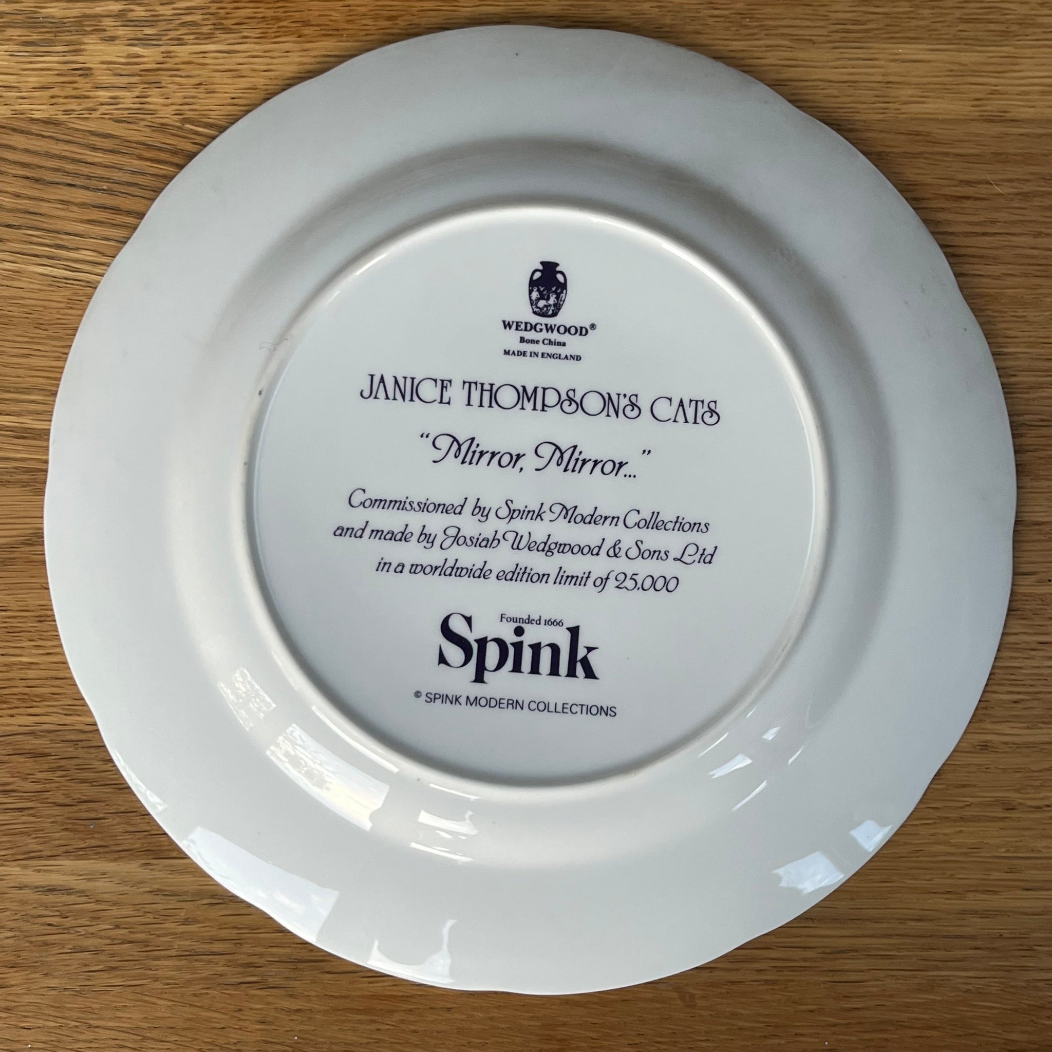 White plate with engraved text on a wooden surface