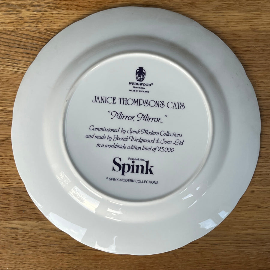 White plate with engraved text on a wooden surface