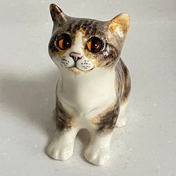 Ceramic Winstanley cat figurine size 2 with tortoiseshell pattern on a light gray background