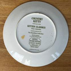 White plate with 'Country Kitty' branding on a wooden surface