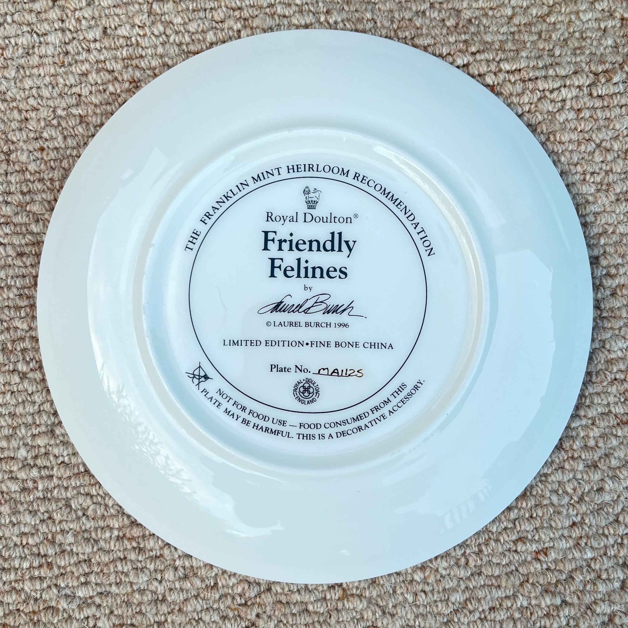 White plate with a black label on a beige carpet