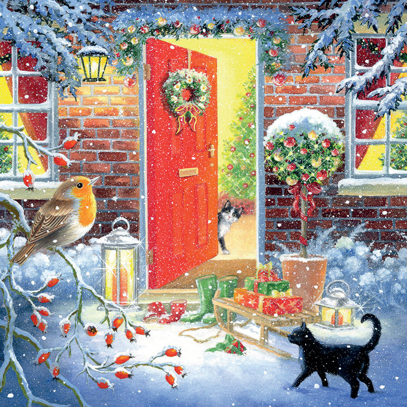 Winter scene with a red door, gifts, cats and a robin in a snowy setting.
