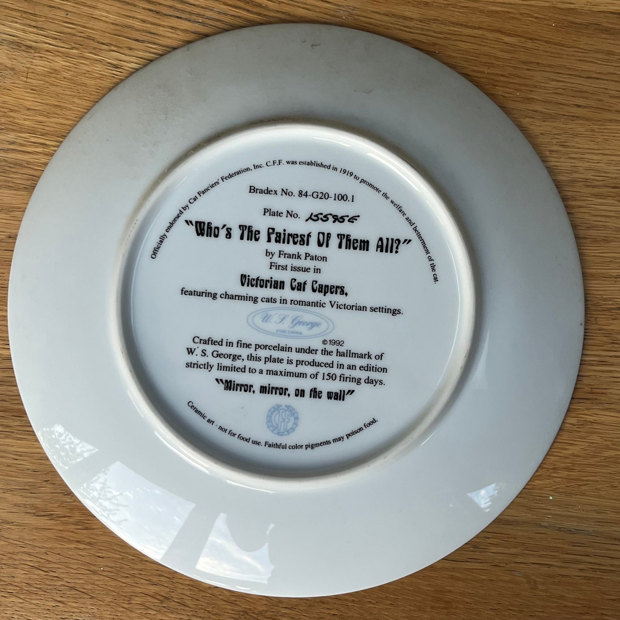 White ceramic plate with text and a logo on a wooden surface