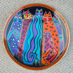 Decorative plate with colorful abstract designs on a textured surface