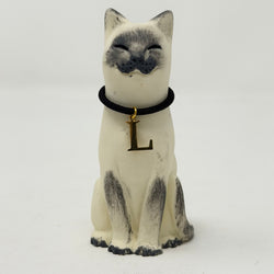 A  Lucky Cat figure hand painted to look like a blue point Siamese with a navy collar and L charm. Front view.