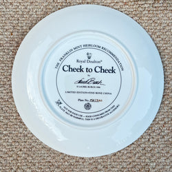 White plate with 'Cheek to Cheek' branding on a beige carpet