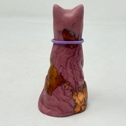 A marbled aubergine-coloured lucky cat figurine wearing a purple collar with a gold letter 'P' charm, set against a plain light grey background. Rear view.