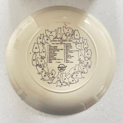 Decorative plate with animal illustrations and text on a white background