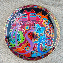 Colorful decorative plate with abstract designs on a textured surface