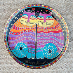 Colorful decorative plate with cat design on a textured surface