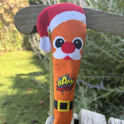 An orange plush Christmas ornament shaped like a carrot, featuring a Santa hat, face, and a 'BAM' logo