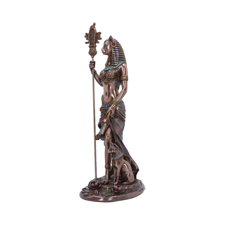 Bronze statue of an Egyptian goddess holding a staff on a white background