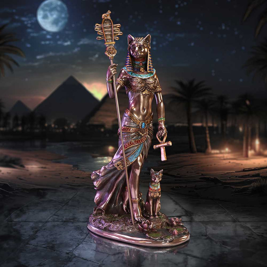 Statue of a Egyptian deity with pyramids and night sky in the background