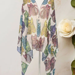 A lightweight scarf or kimono-style wrap displayed on a mannequin stand, featuring a colourful print of stylised cats in muted purple, blue, green, and yellow tones