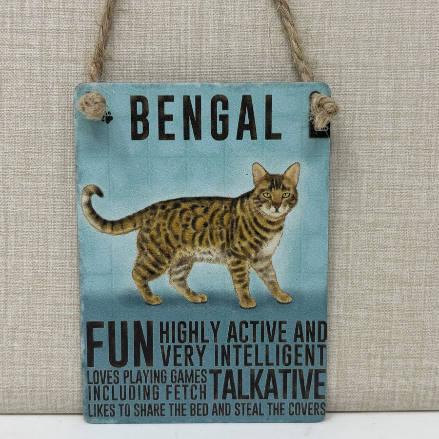 A rectangular hanging sign with a light blue background featuring a painted Bengal cat and black text reading 'BENGAL' and descriptive phrases. 