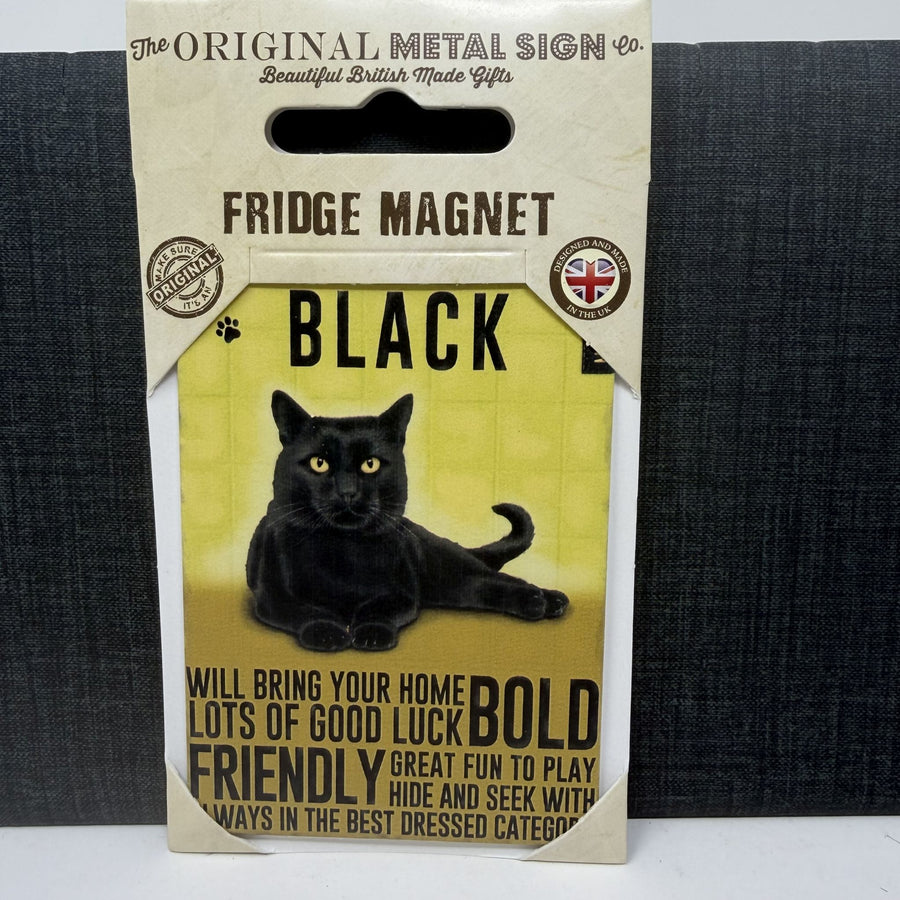 A packaged black fridge magnet shaped like a hanging card, featuring a black cat illustration and text that reads 'FRIDGE MAGNET' and 'BLACK'. 