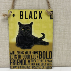 A rectangular hanging sign featuring a black cat illustration and bold black text that reads 'BLACK' and decorative phrases about luck and friendliness. 