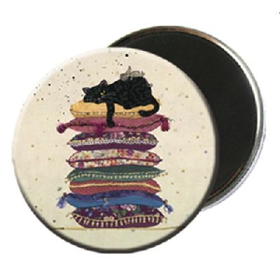 Black Kitty Fridge Magnet cat on pile of cushions