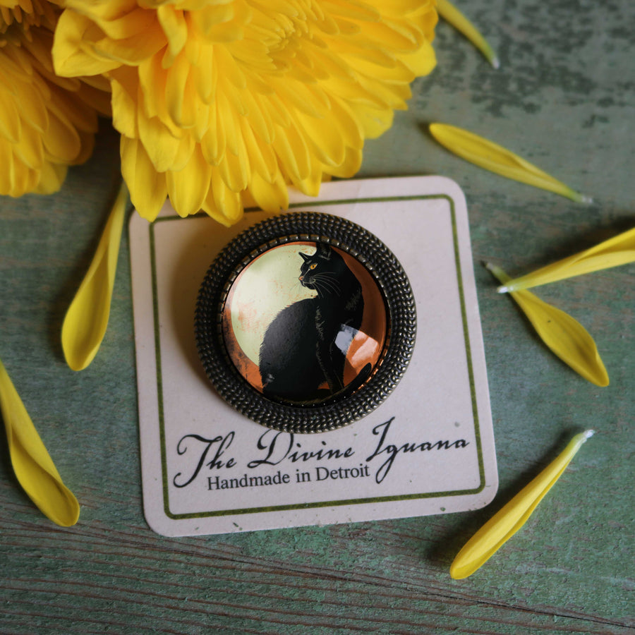 Black cat brooch on a card with yellow flowers