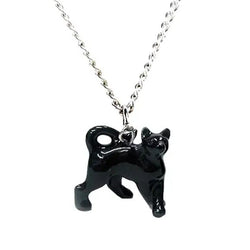 Black cat shaped charm hanging on a silver coloured pendant