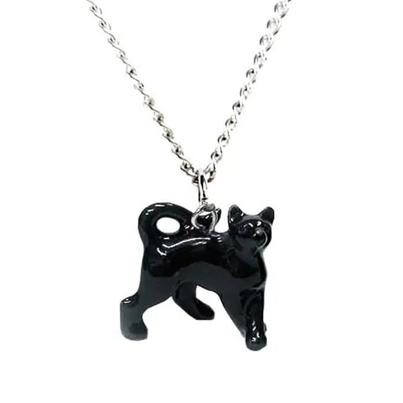 Black cat shaped charm hanging on a silver coloured pendant