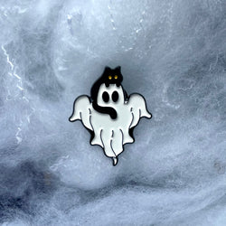 A Black Cat sitting on the head of a white ghost against a blue white background