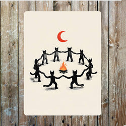 A rectangular sign illustration of black cats holding hands in a circle around a small orange fire under a red crescent moon
