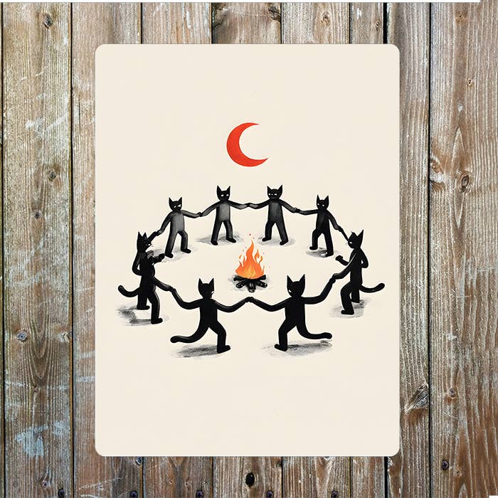 A rectangular sign illustration of black cats holding hands in a circle around a small orange fire under a red crescent moon