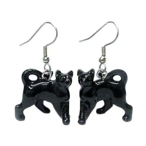 A pair of black porcelain earrings shaped like cats in a running pose, with surgical steel hooks