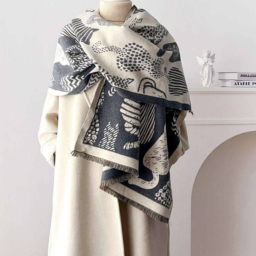 Mannequin wearing a cat patterned scarf with a neutral background