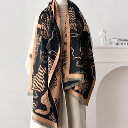 Black and beige cat patterned scarf on a mannequin against a white background