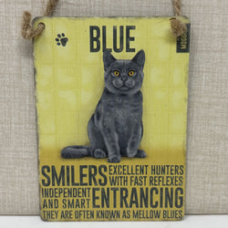A rectangular hanging sign with an illustration of a grey blue cat. The sign reads “BLUE” at the top and includes descriptive text about the cat