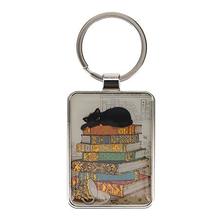 Black Kitty Keyring. Cat lying on a pile of books
