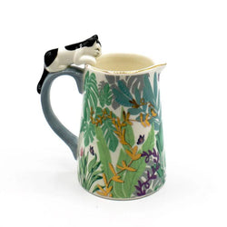 Decorative mug with a cat design on the handle against a white background