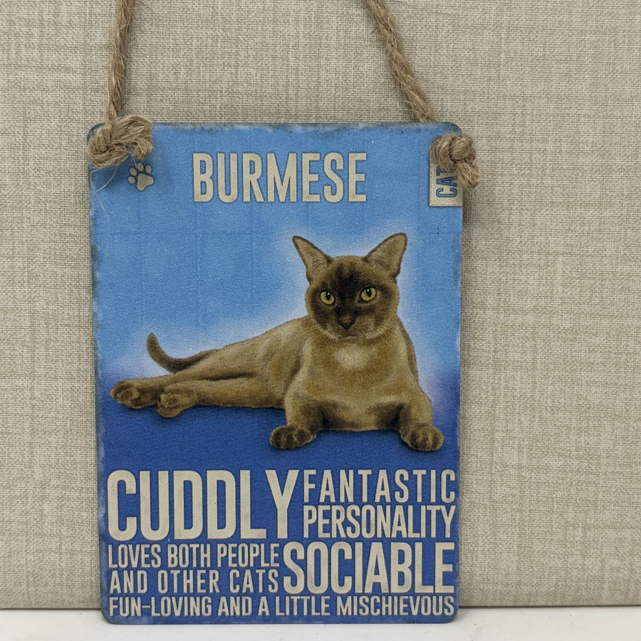 A rectangular hanging sign with a rope hanger, featuring a photo of a brown Burmese cat on a blue background with text describing the cat's personality.
