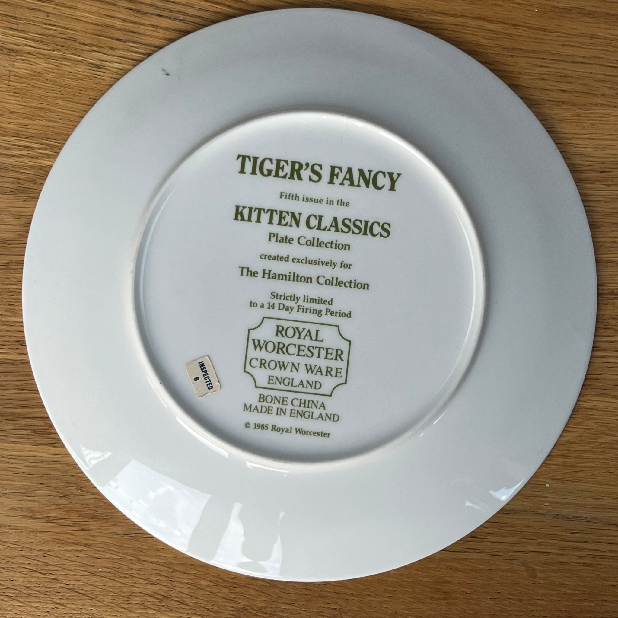 White plate with text on a wooden surface