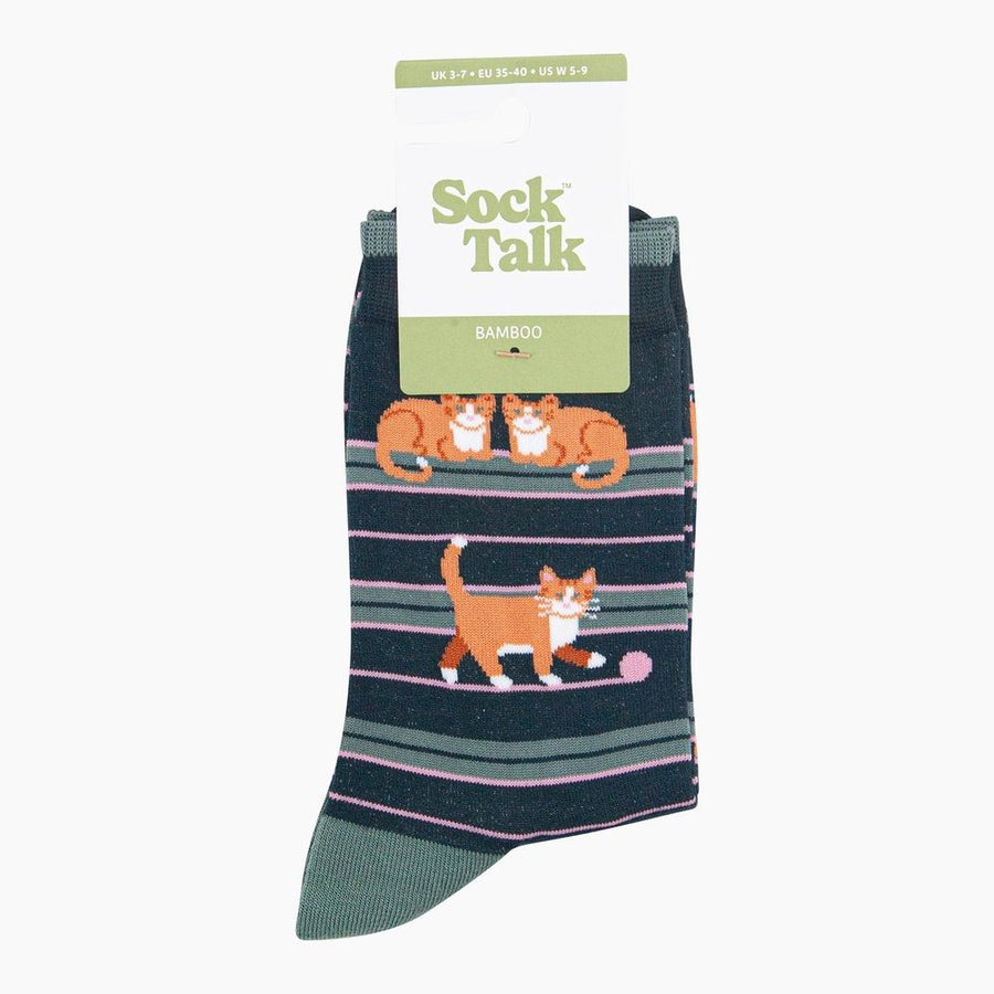 A pair of Sock Talk Bamboo crew socks featuring orange tabby cat illustrations on a navy blue striped background