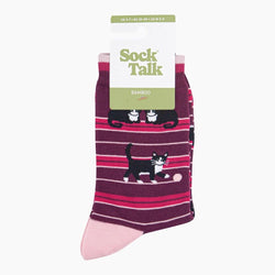 A pair of Bamboo crew socks in a dark purple and pink striped pattern with black and white cat illustrations