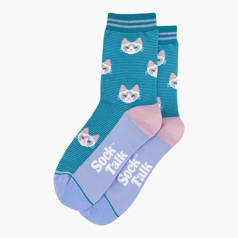 A pair of crew socks, featuring a teal blue upper with a repeating pattern of white and pink cat faces, and a light lavender lower section