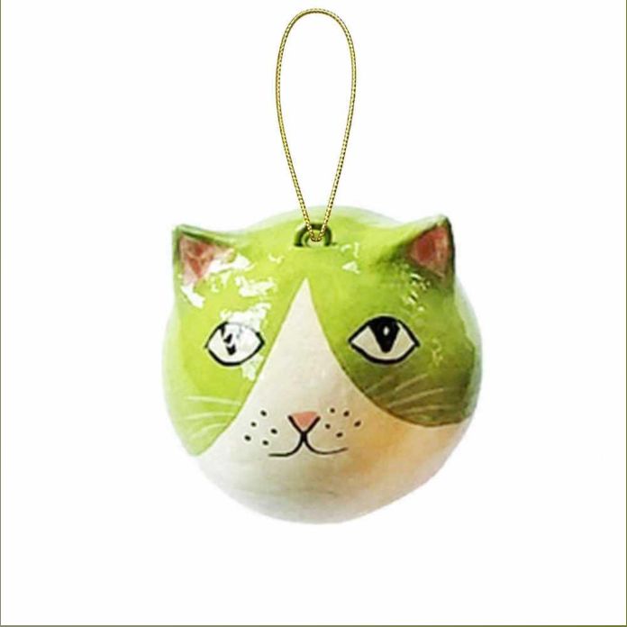 A cat head Christmas ornament with a glossy finish, featuring green and white coloring, black and white eyes, and a gold hanging loop at the top
